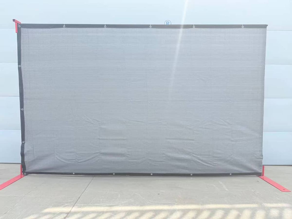 HDPE privacy screen mounted on a temporary fence frame